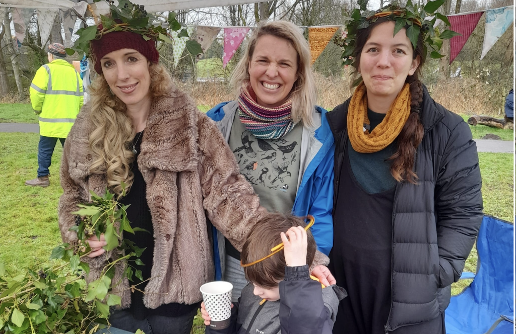 3x adult and 1x child 'Frome Families for the Future' volunteers at a local event near the river
